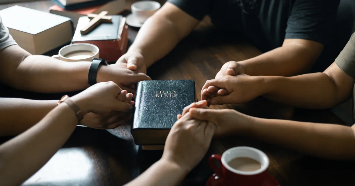 Believers standing united in prayer, symbolizing church unity against a kingdom divided against itself